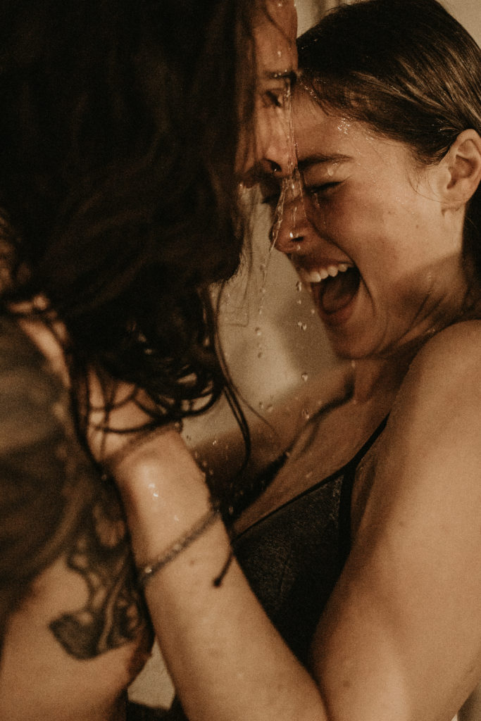 woman laughing under shower
